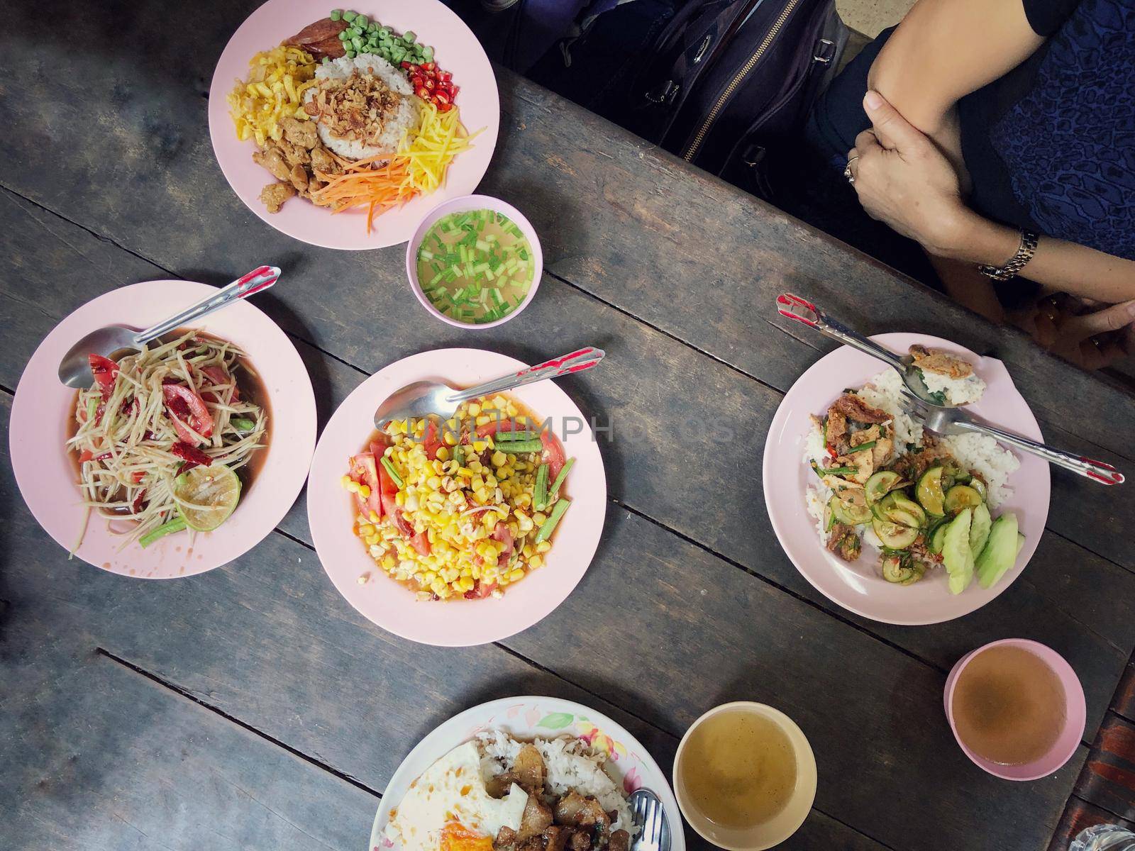 Top view Thai food on table: Eating north eastern foods (SOM TUM - Spicy Papaya Salad, Sticky rice). Local and traditional way. Thai Food Background. enjoy eating concept