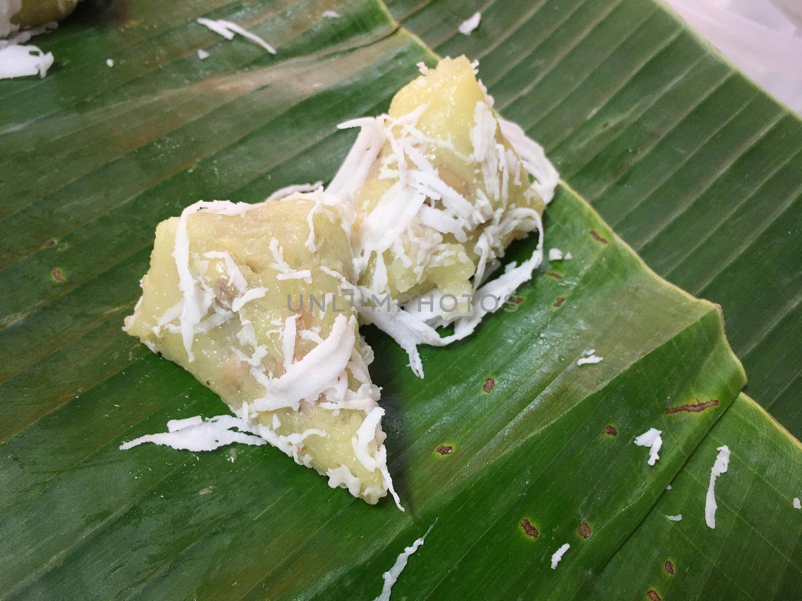 Sweet boiled ball with coconut on banana leaf, This Thai desert is called " Khanom Tom"Thai style desert in the North of Thailand..  Thai traditional desert.