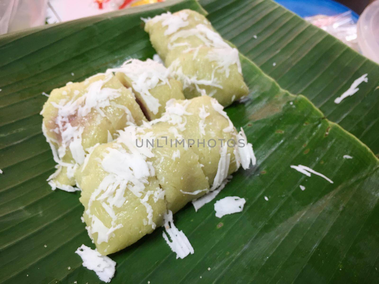 Sweet boiled ball with coconut on banana leaf, This Thai desert is called " Khanom Tom"Thai style desert in the North of Thailand..  Thai traditional desert.