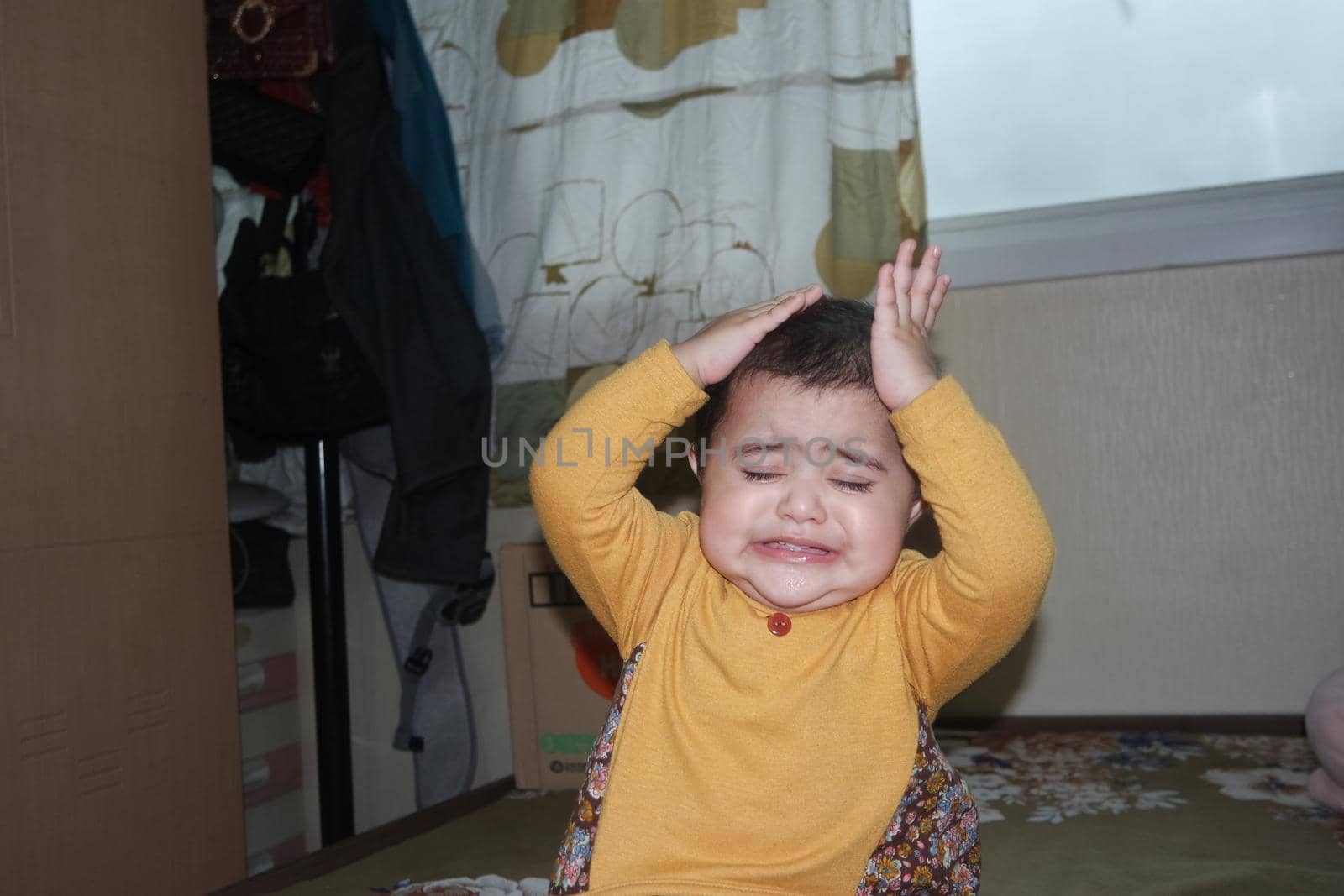 Baby girl with lovely face, big eyes and cute face gesture. Toddler baby making sweet activities