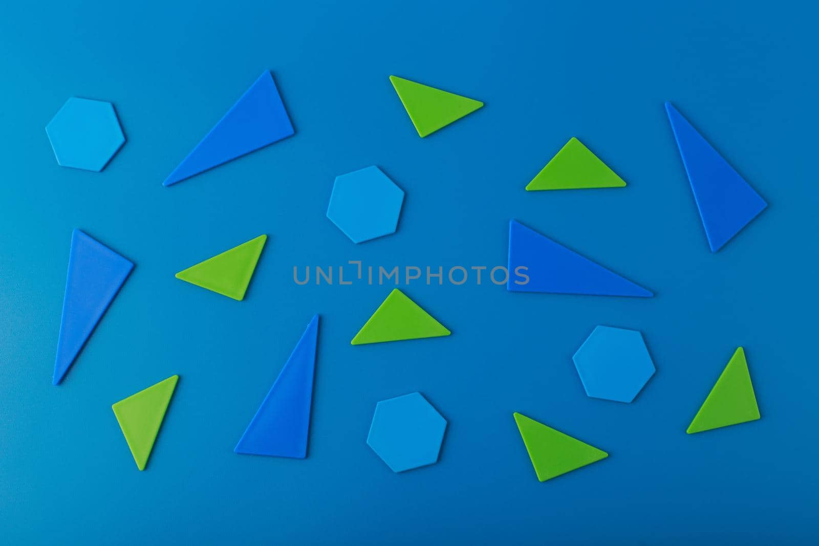 Flat lay with blue and green geometric figures on blue background. Template for advertising banner by Senorina_Irina