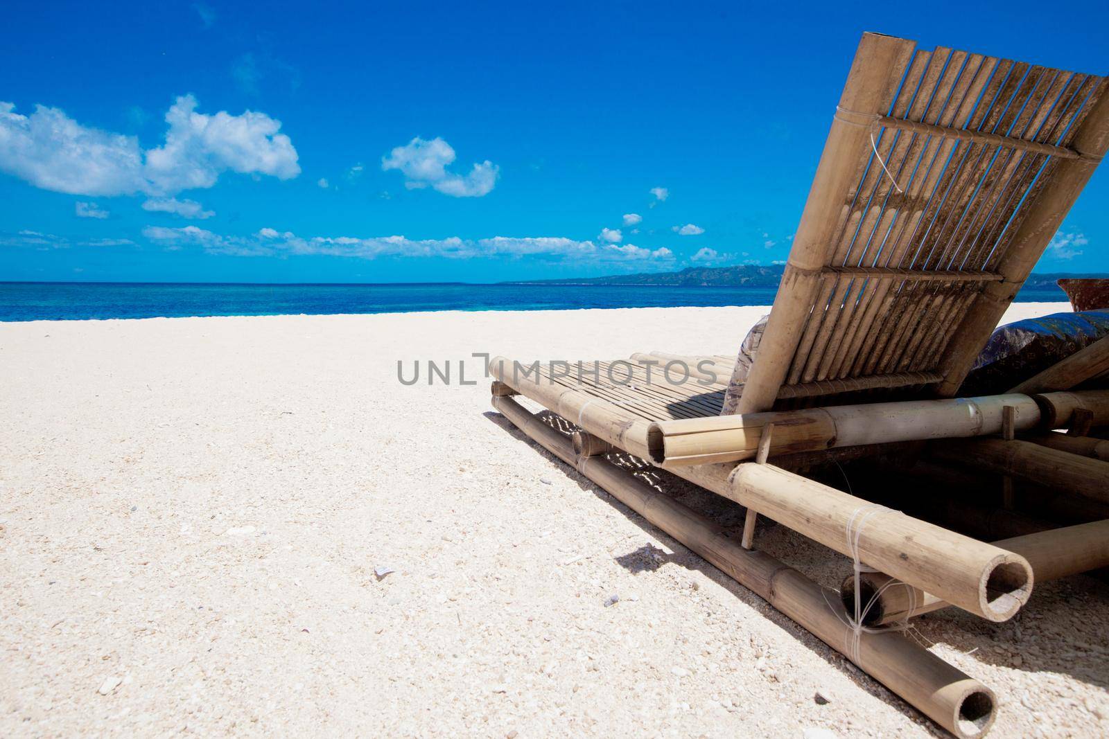 Beach chair made of straw and bamboo at beautiful tropical sea beach