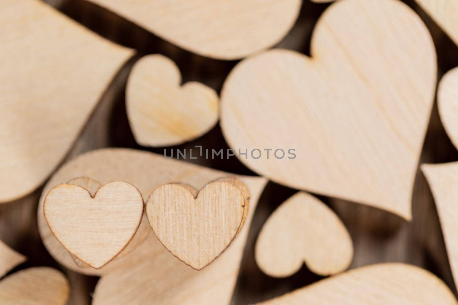 Many wooden colorless hearts background, two special ones true love concept