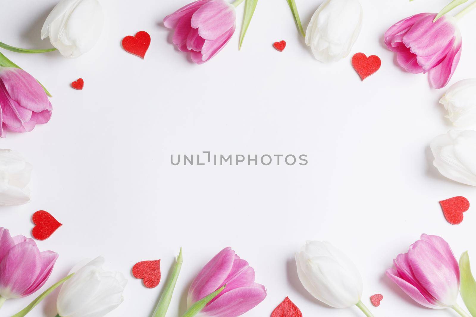 Frame made of colourful tulips and red hearts Valentines day background