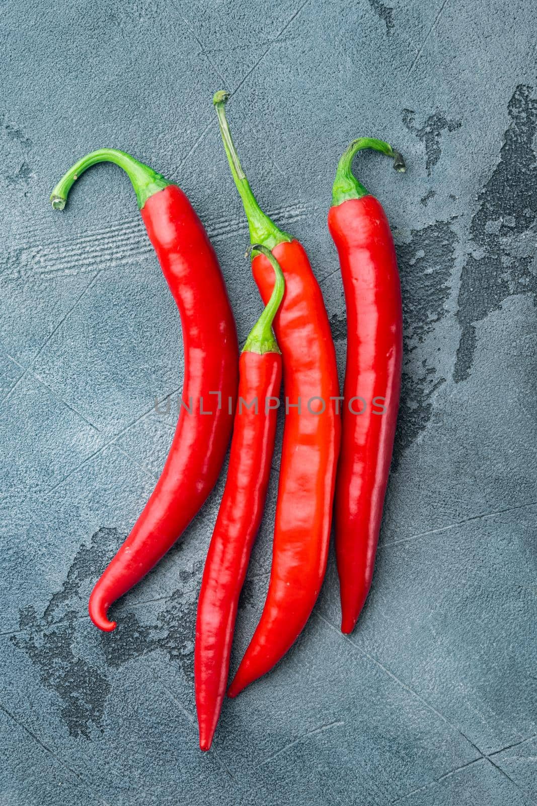 Whole red chili peppers set, on gray background, top view or flat lay