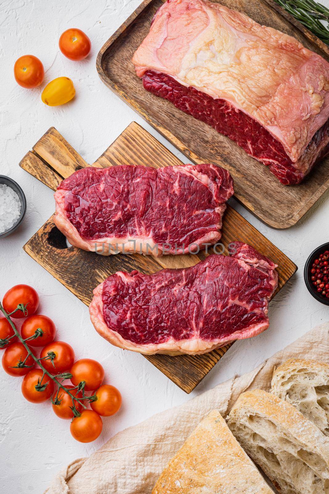 Raw beef steak burger ingredients, with marbled meat, on white background, top view