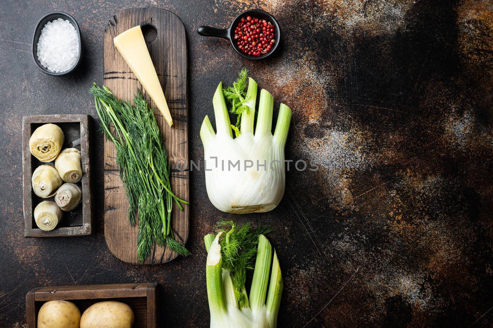Fennel and artichoke with parmesan raw ingredient, on old rustic background, flat lay with space for text