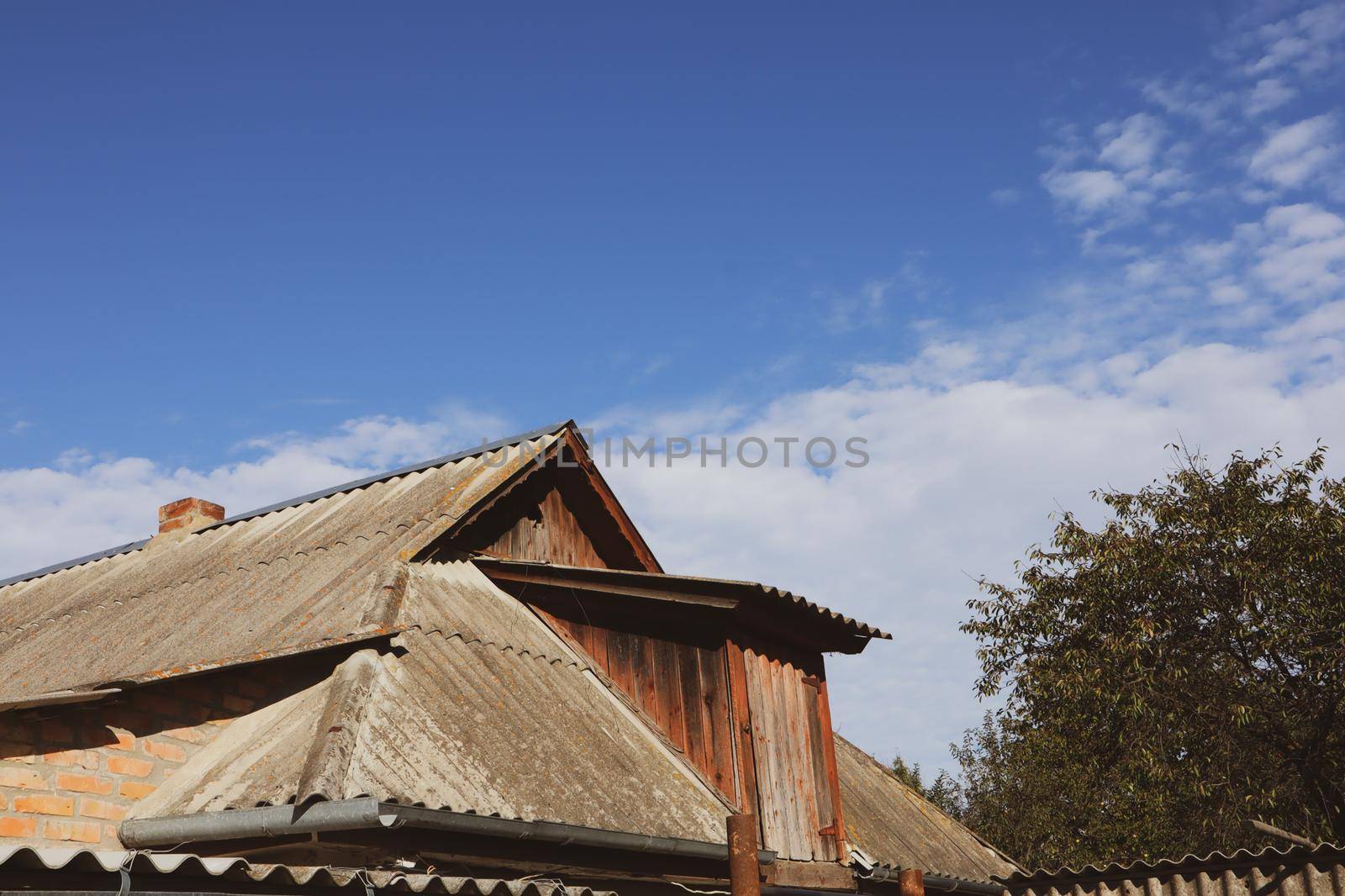 The roof of the house is covered with slate on a background of sky