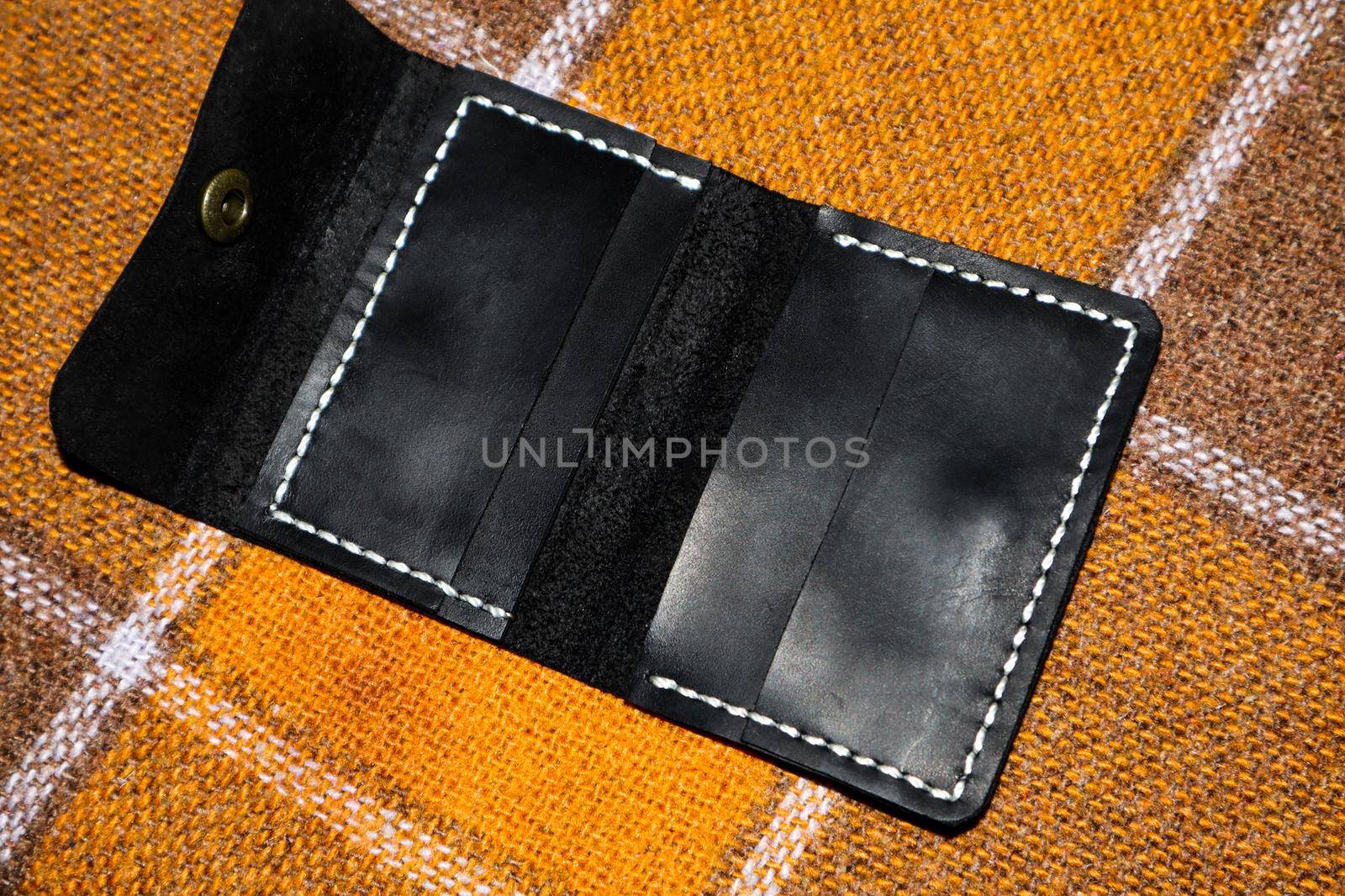 Leather wallet stitched with white threads on