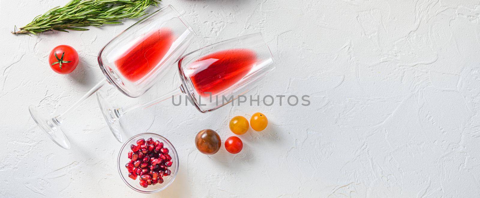 Two glass of red wine near herbs for grill over white concrete table top view. Big banner size. Space for text