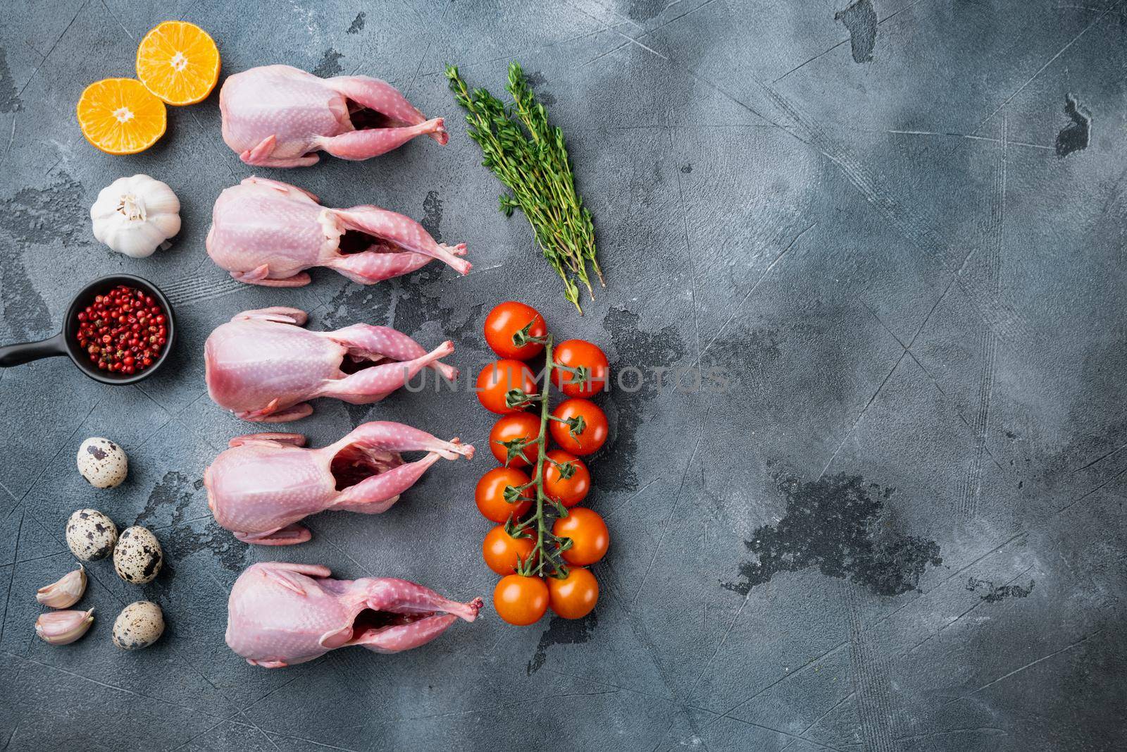 Homemade eco friendly raw quail, top view, on grey background with copy space