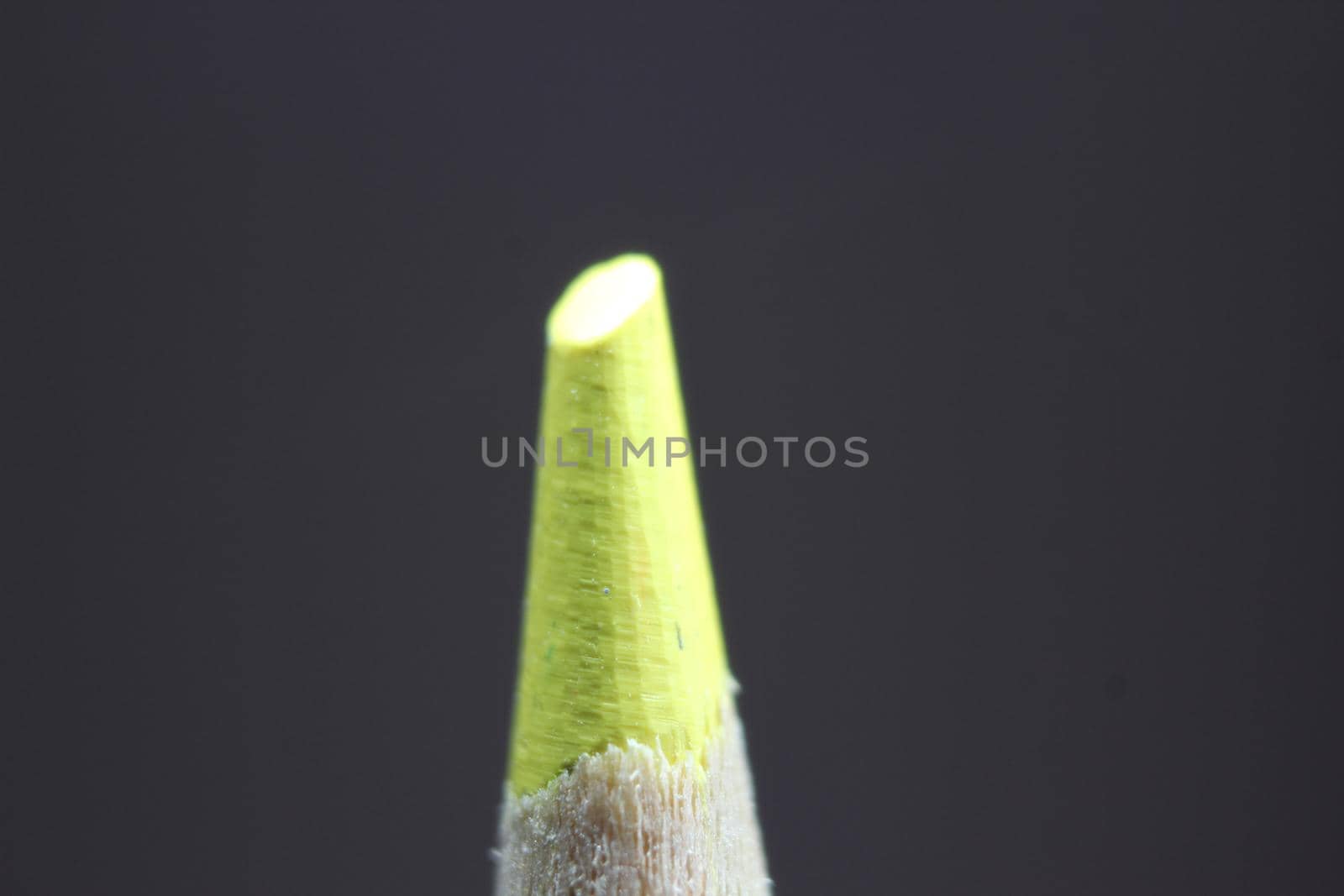 close up of sharpened pencil.Macro view of the tip of the pencil on a black background.