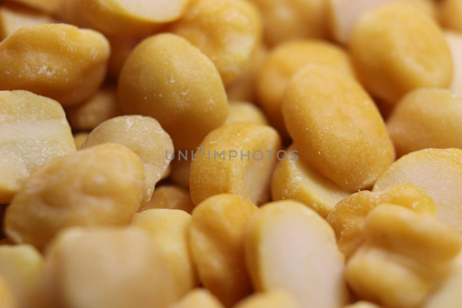 Yellow chickpea lentils seeds macro closeup view. Chana daal or yellow split peas spread background