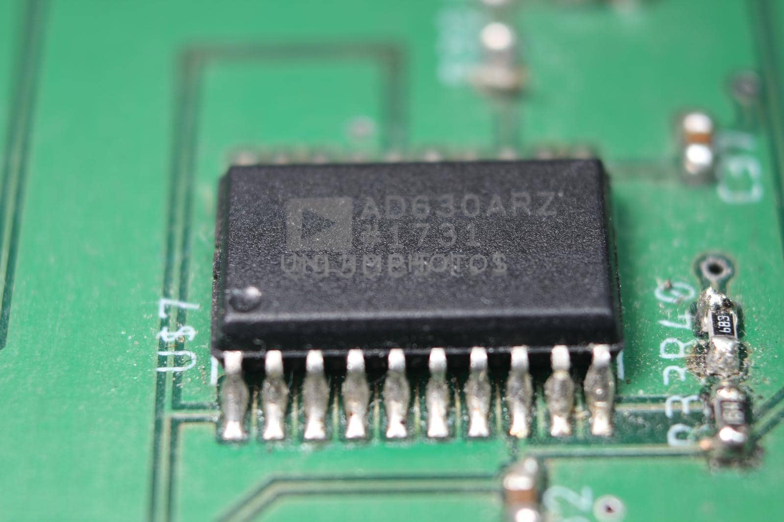 Electronic board with circuit lines and chip. Macro view of green board