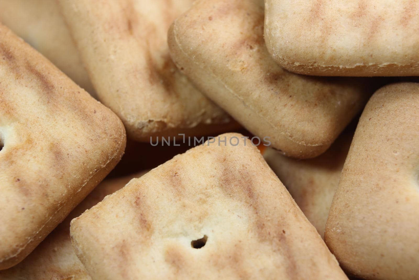 Close up view rectangular biscuits with small pores by Photochowk