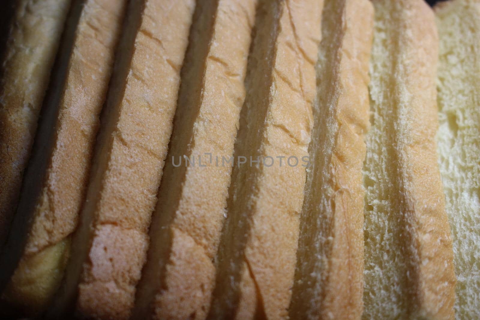 Closeup top view of freshly prepared slices of toast bread. Food background for bakery products