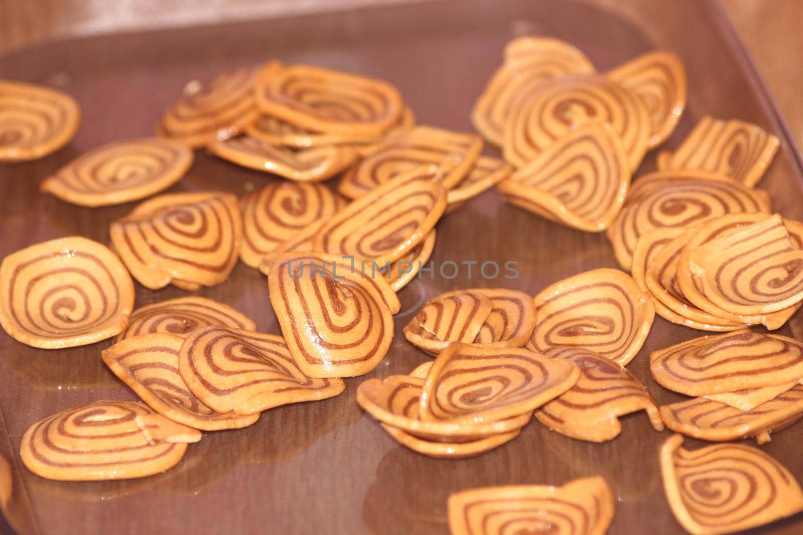 Closeup view with selective focus of a large number of round cookies by Photochowk