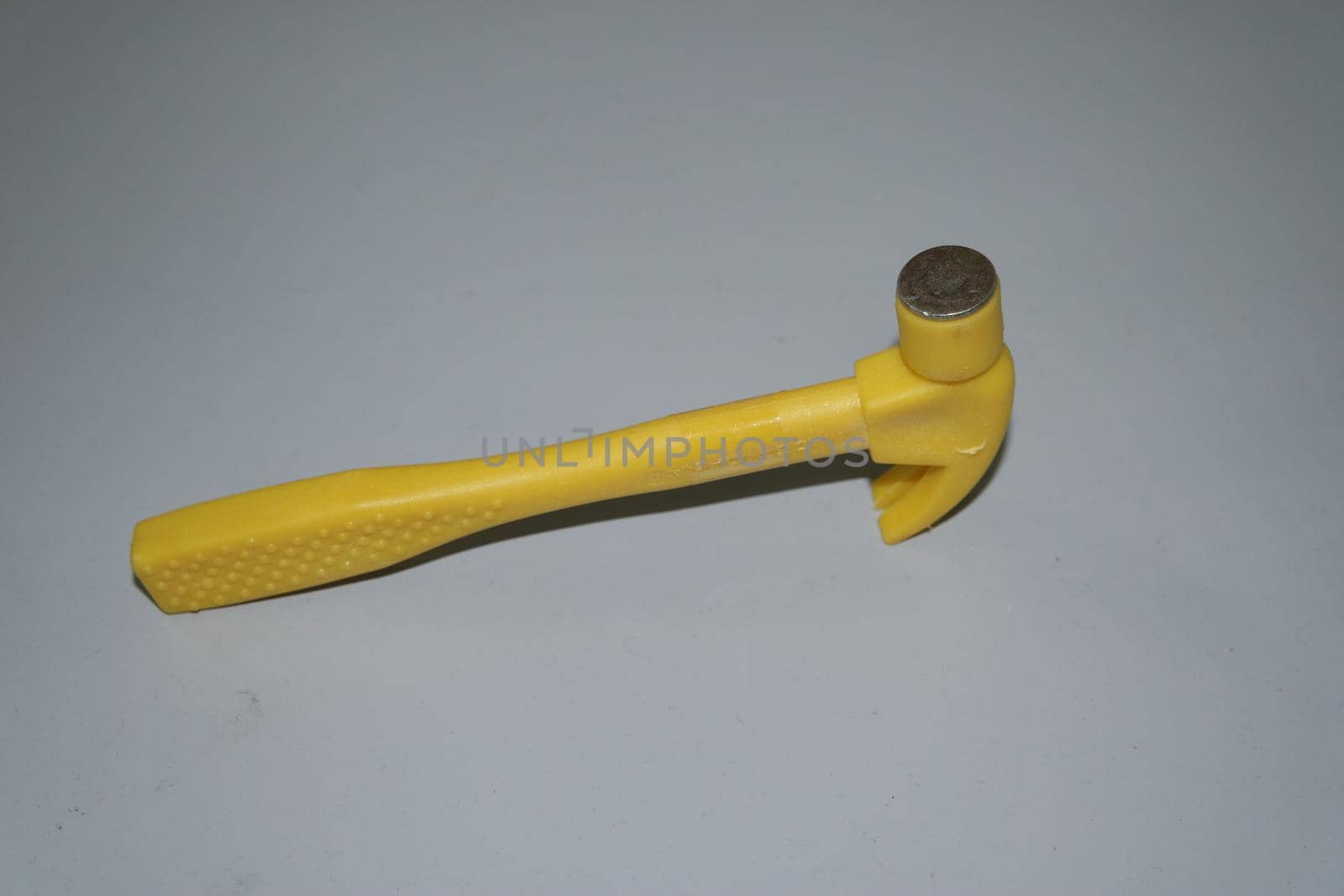 Selective focused, closeup view of toy hammer made from plastic by Photochowk