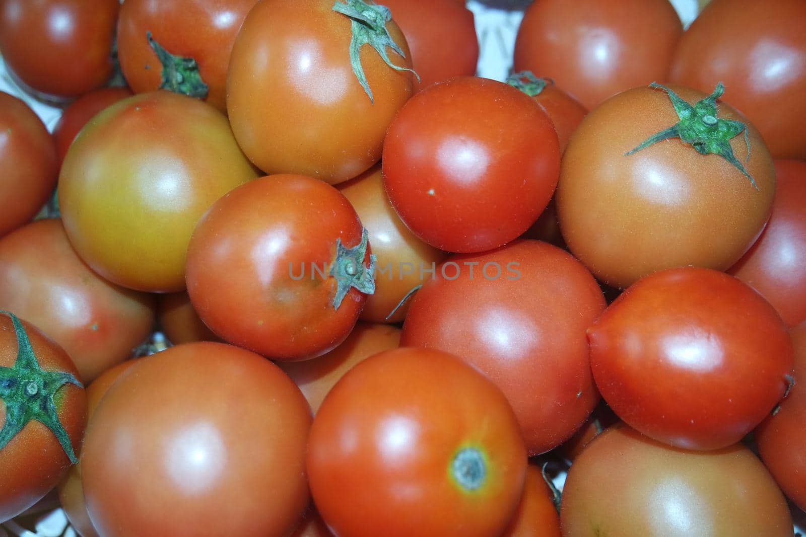 Close-up view of red tomatoes in market for sale. A fruit background for text and advertisements