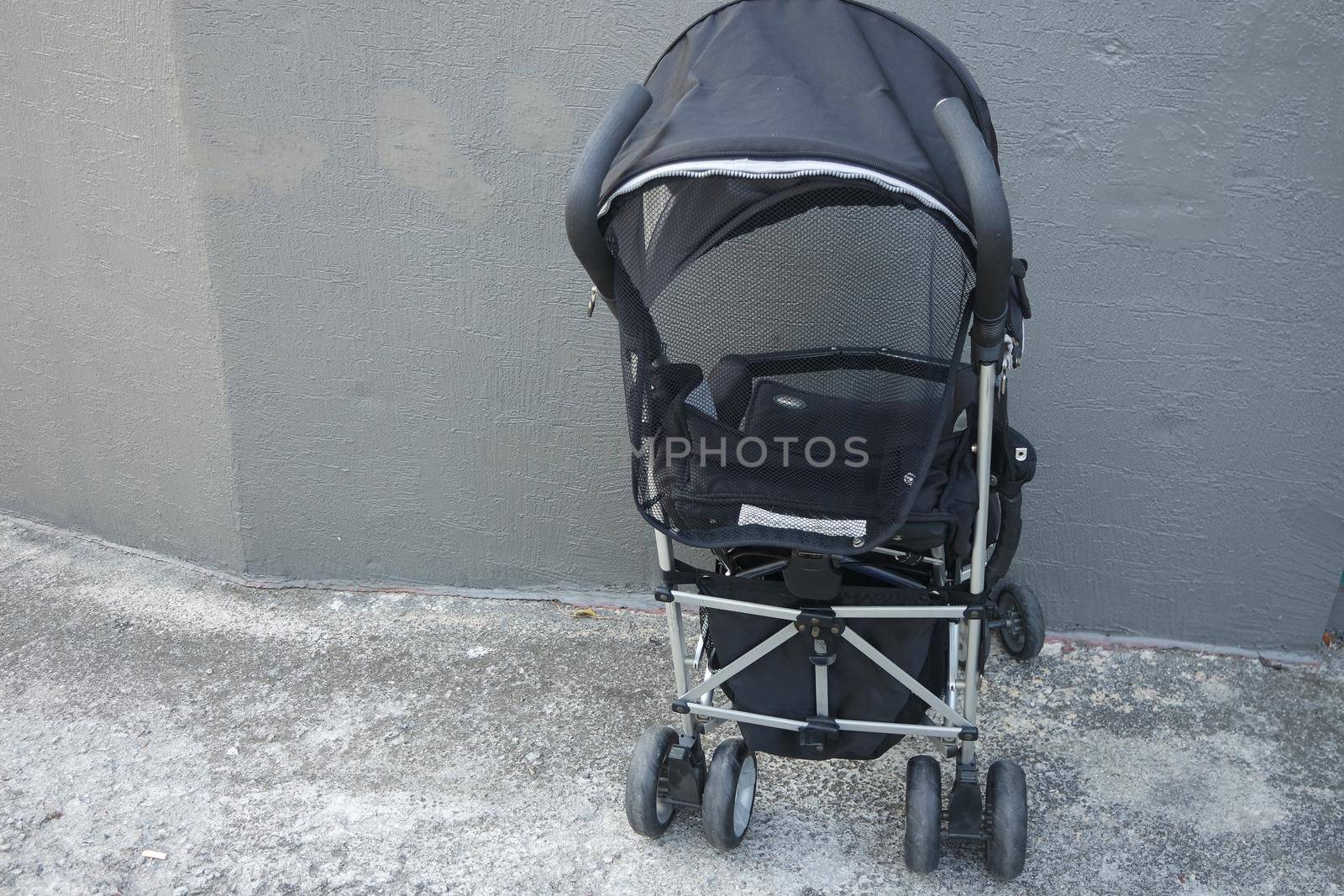 Black color baby stroller with head covering by Photochowk