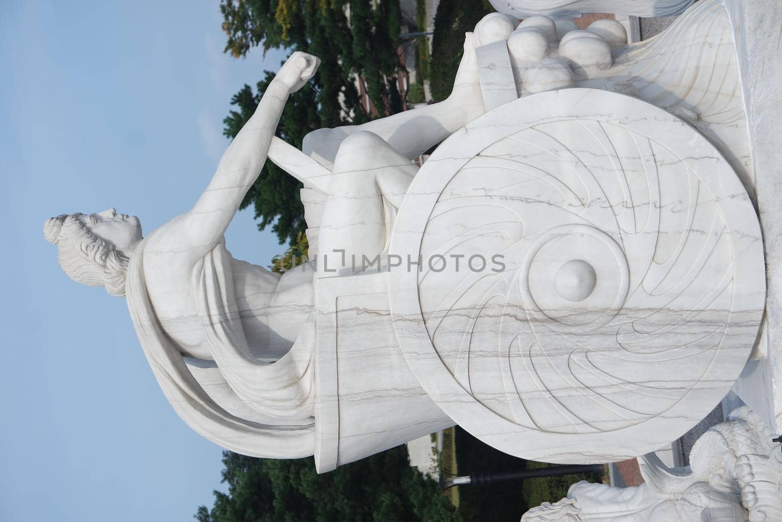 White marble stone statue of Poseidon or Neptune sitting by Photochowk