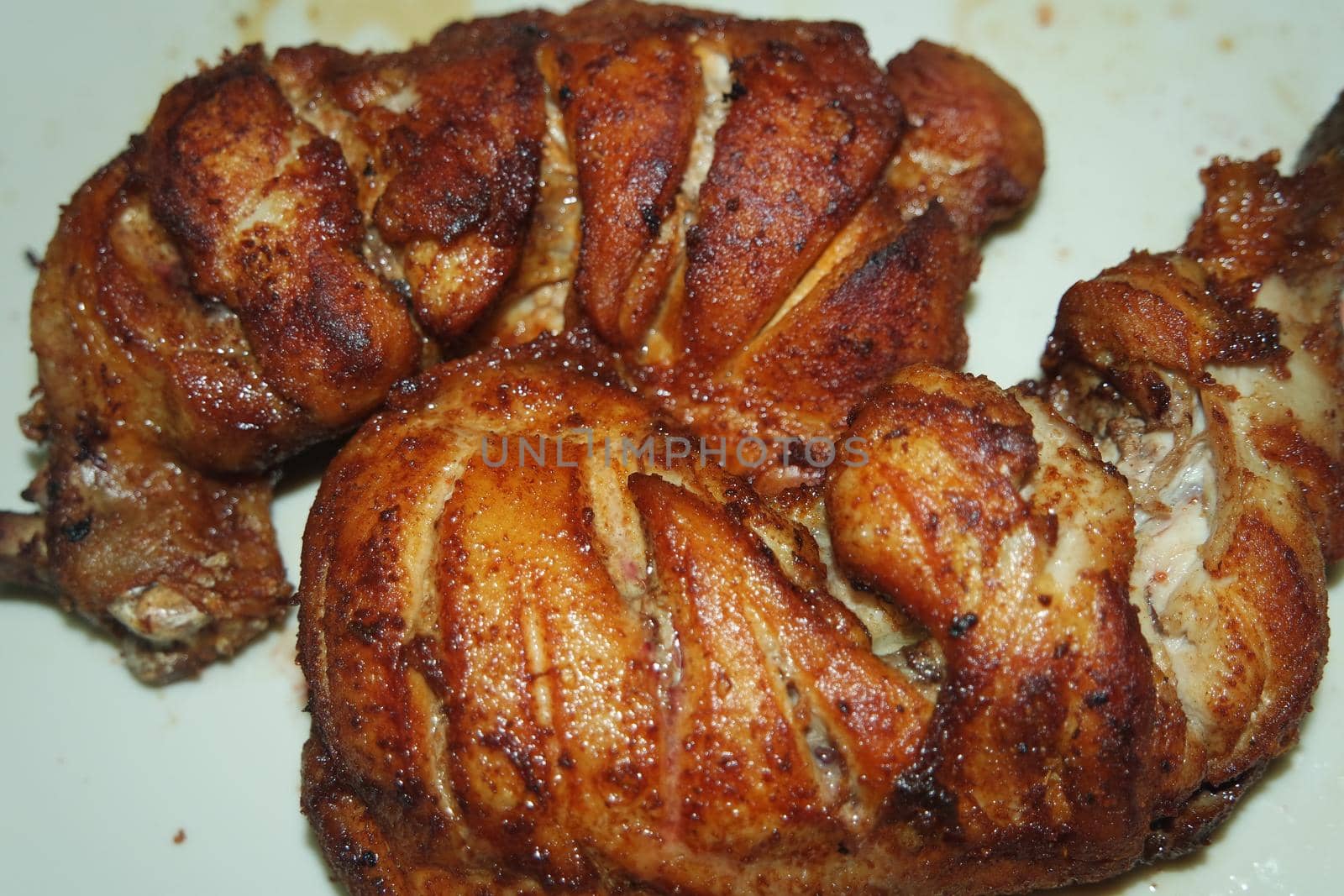 Fried, grilled baked chicken pieces with marinated spices on it. Tasty delicious fried chicken barbecue