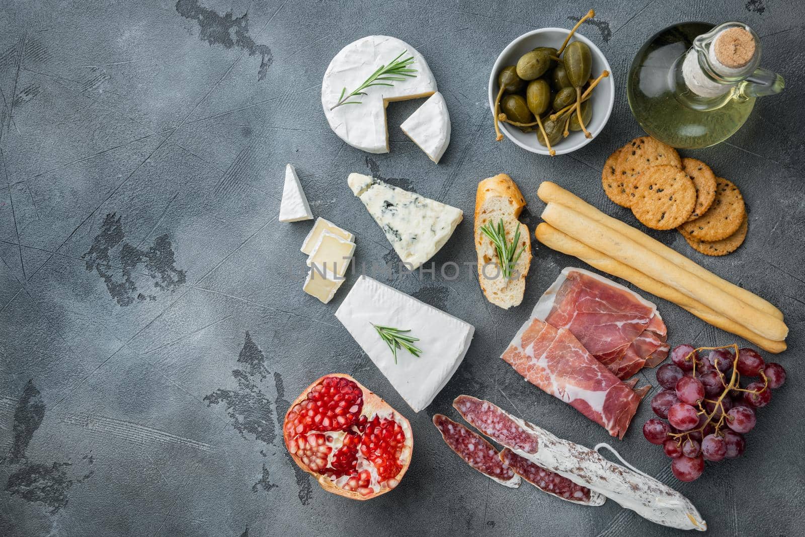 Classic italian antipasti set, on gray background, flat lay with copy space for text