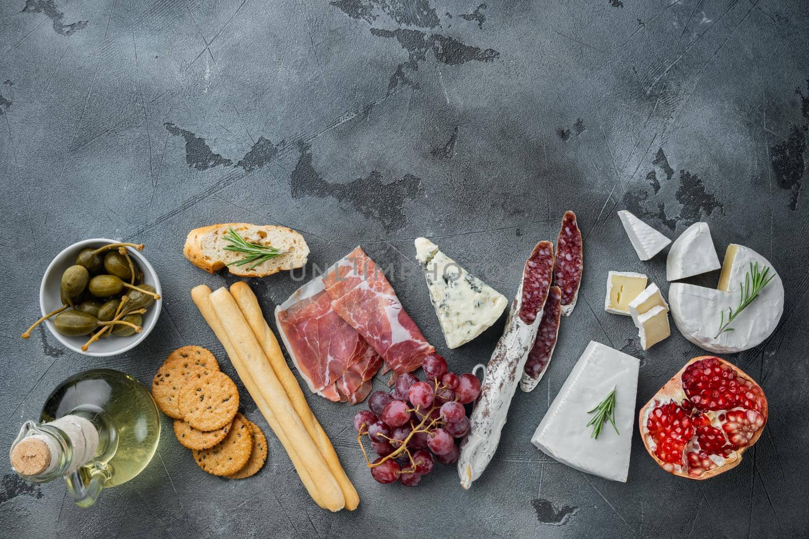 Classic italian antipasti set, on gray background, top view with copy space for text