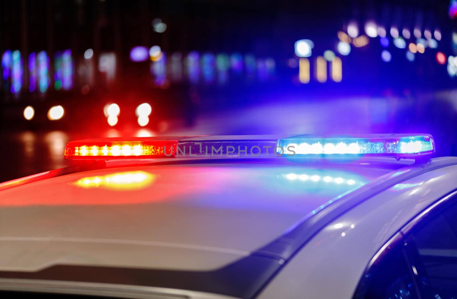 police car lights at night in city with selective focus and bokeh blur