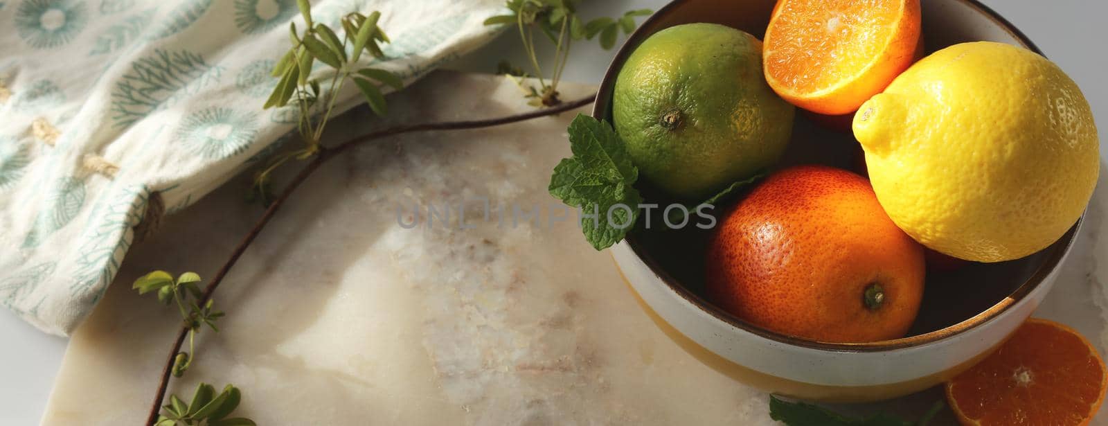 Citrus composition on marble table with canvas