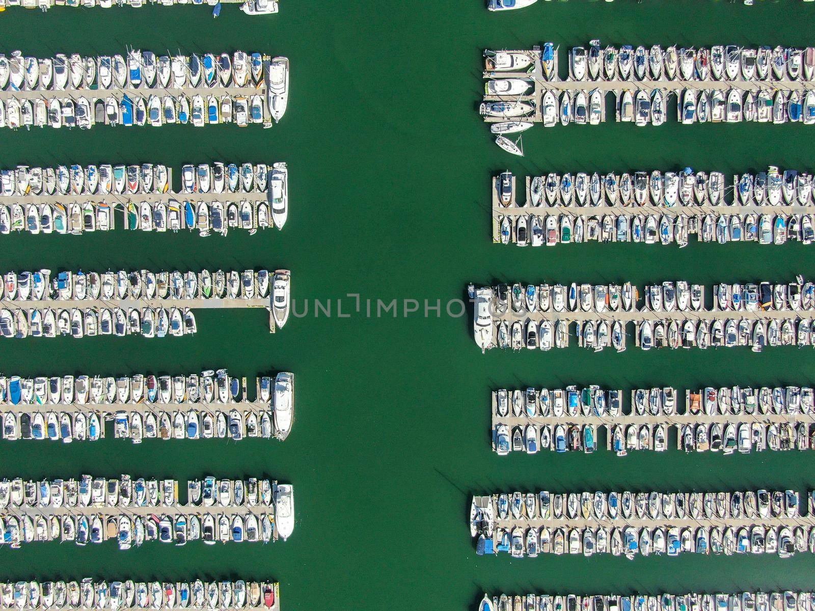 Aerial top view of boats and yachts in marina. Marina lot with yachts, sailboat and speedboat moored at the quay.