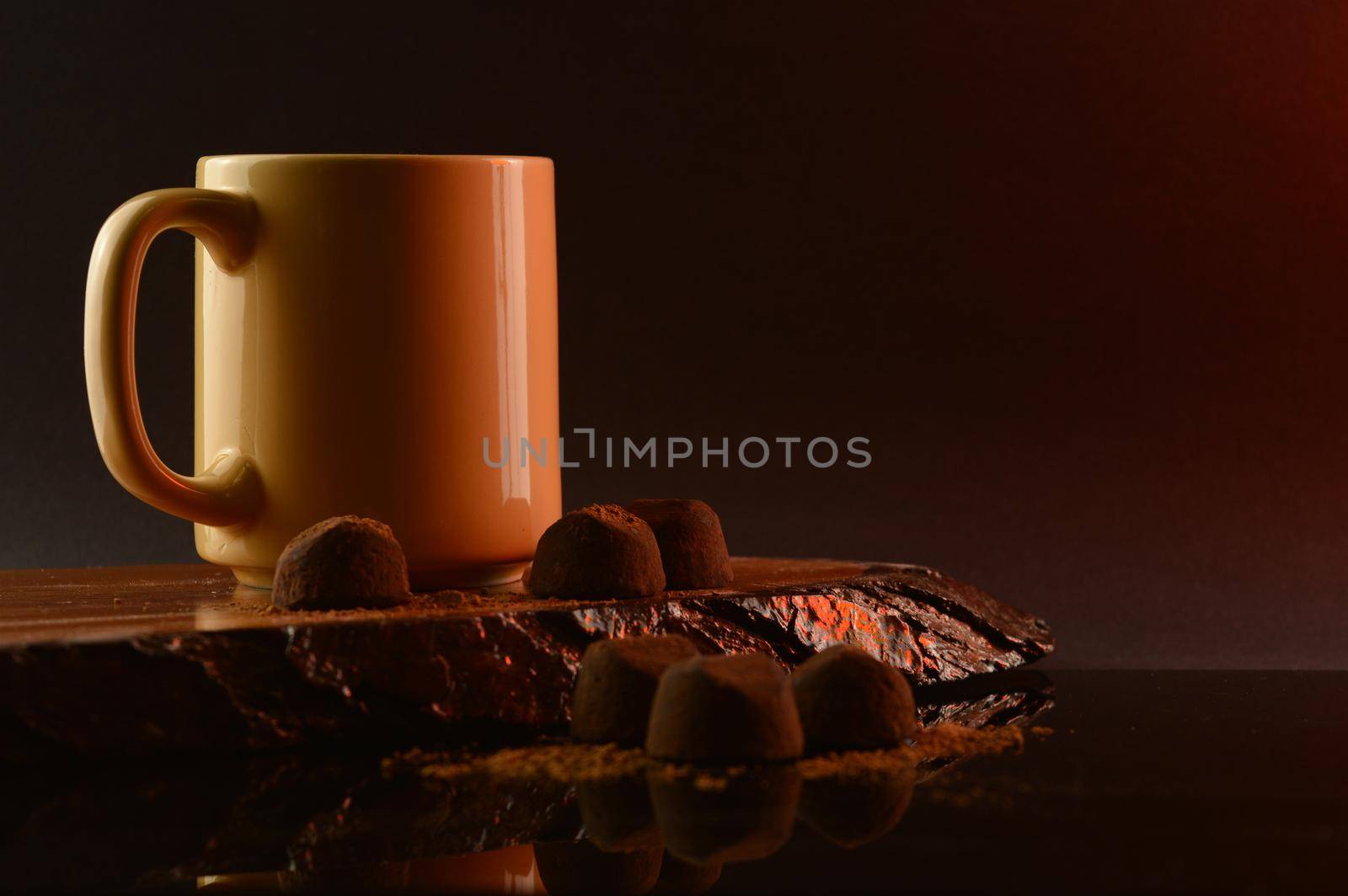 A composition of coffee and fine chocolate truffles for a tasteful display.
