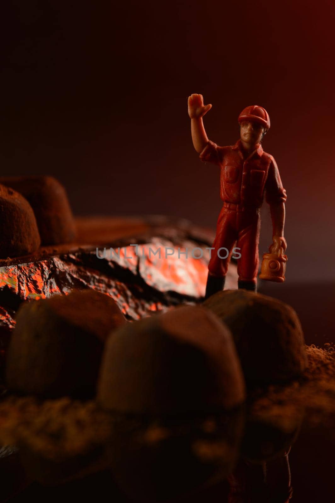 A conceptual image with a chocolate inspector in the scene of some fine truffles.