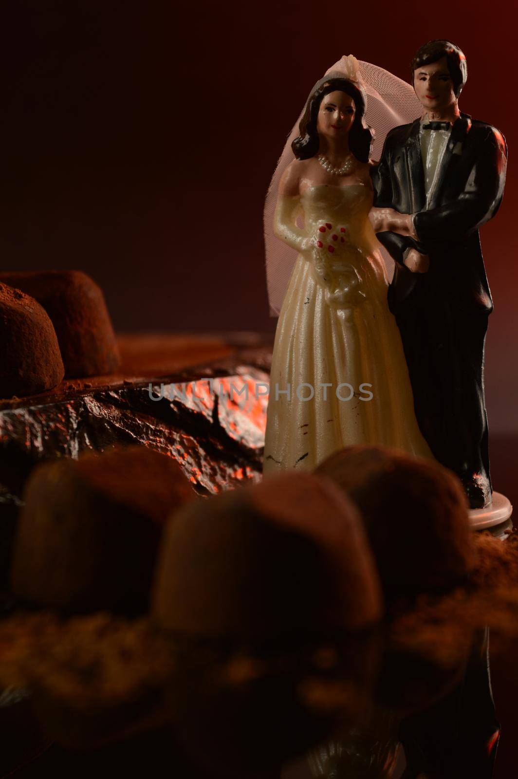 A married couple in a scene of fine chocolate truffles.