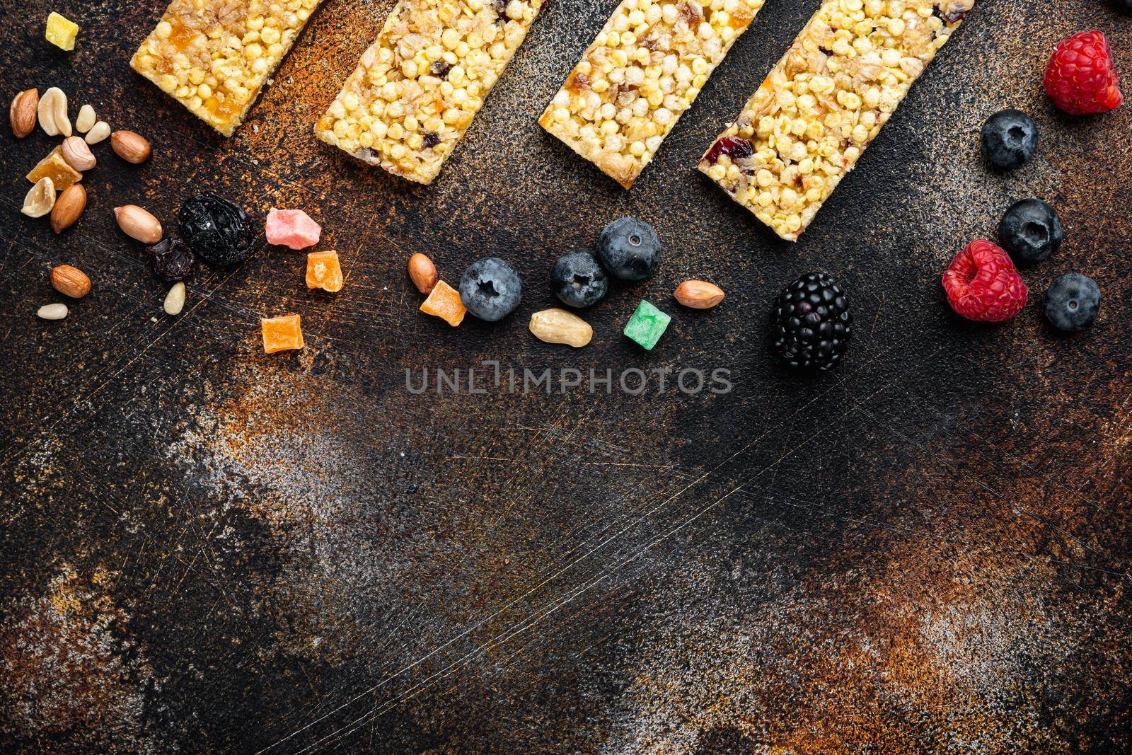 Healthy raw dessert snack. Fitness food. Homemade breadsticks with flax, sunflower, pumpkin seeds, flat lay with space for text, on old dark table
