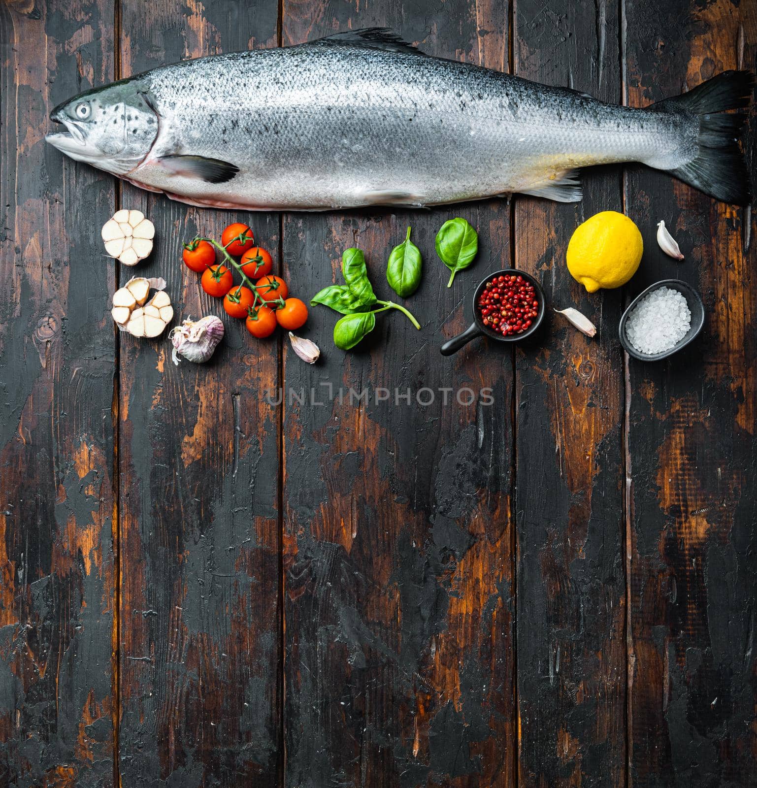 Fresh whole trout on wooden background, top view with space for text.