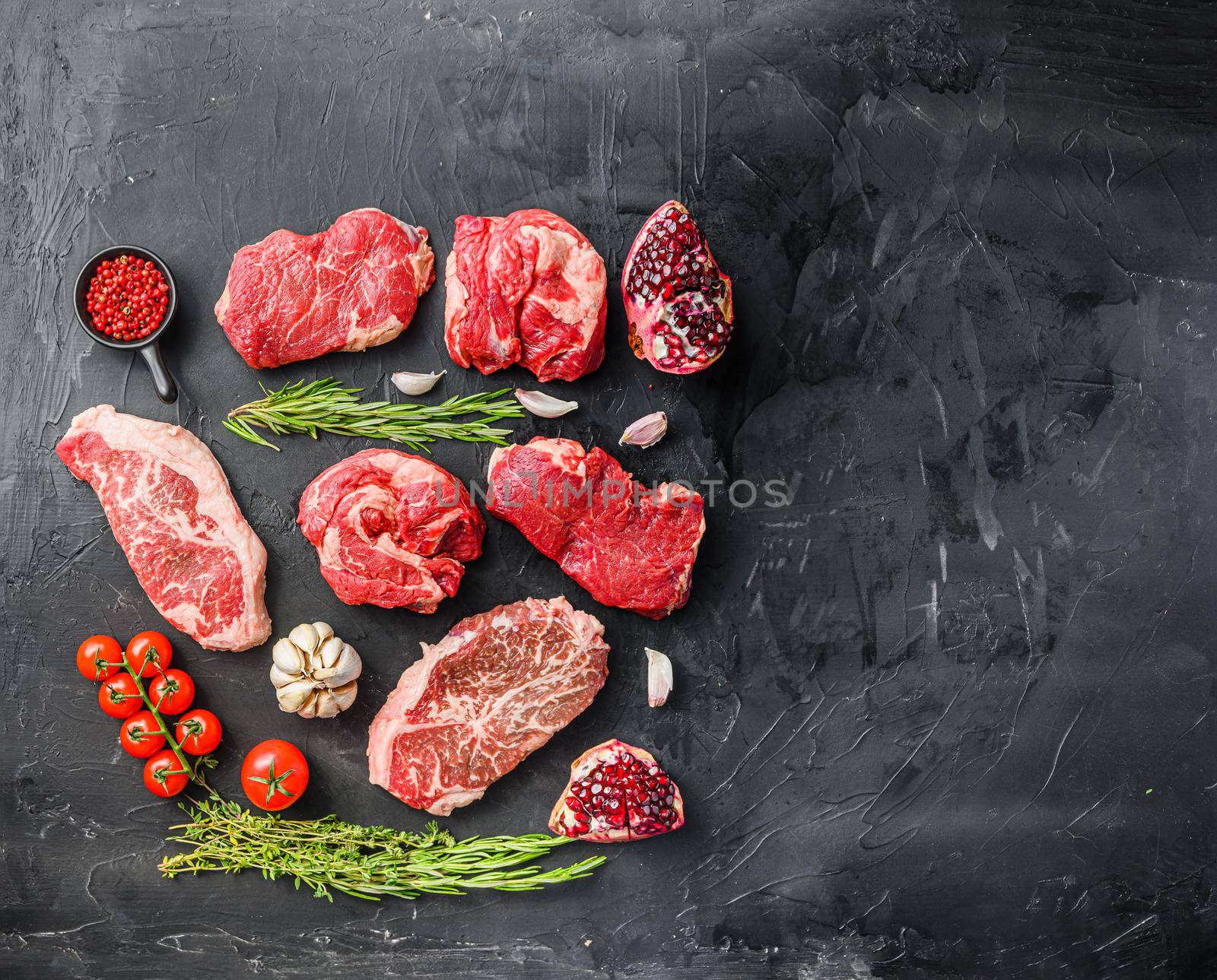 Set of various classic, alternative steaks picanha, ramp and chuck eye rollover black background top view. Big size space for text.