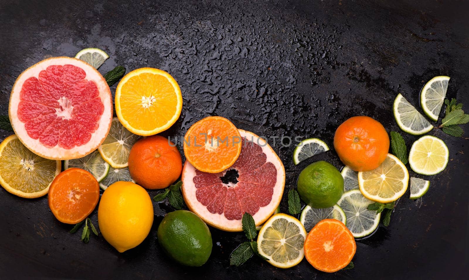 Citrus background. Fresh citrus fruits - Lemons, oranges, limes, grapefruits On wooden background