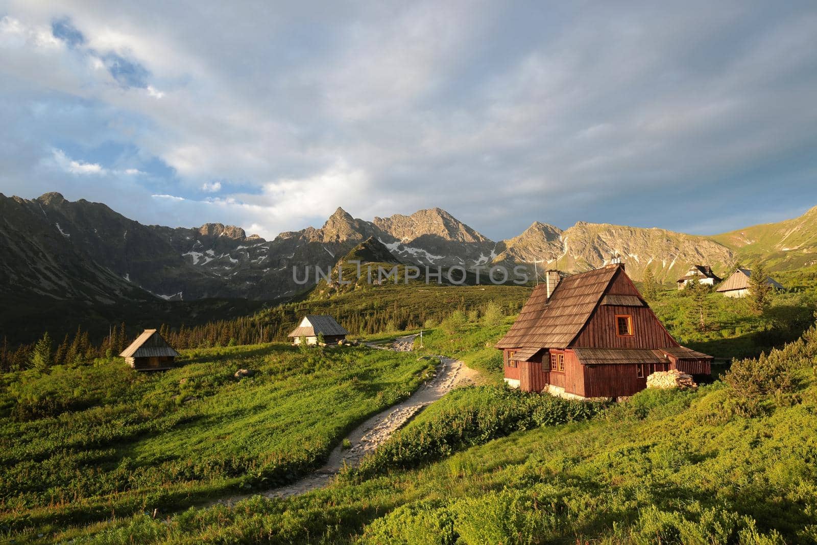 Cottage in a valley surrounded by the Carpathian Mountains.