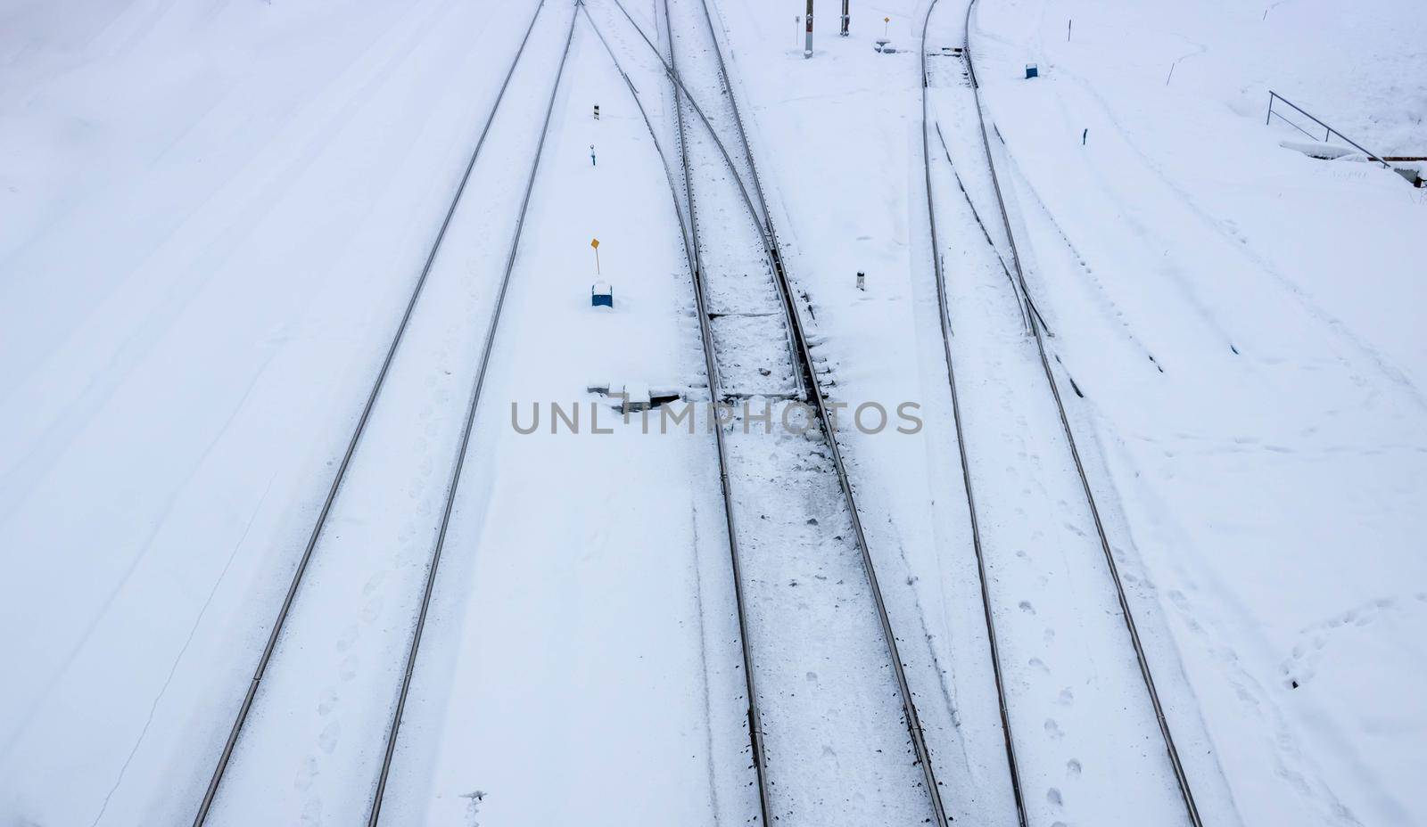 Winter railway road with white snow. Rails in the snow.