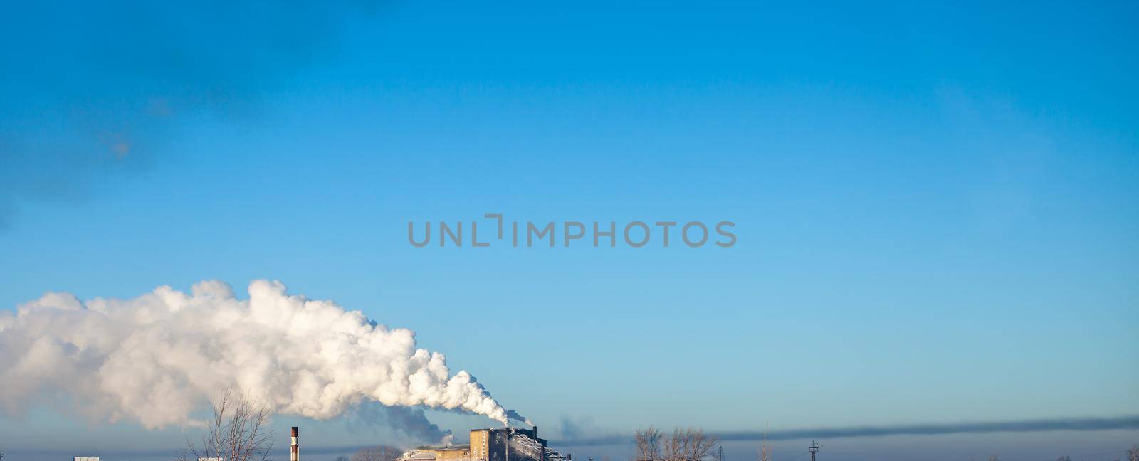 White thick smoke from the boiler room chimney. Industrial zone. by AnatoliiFoto