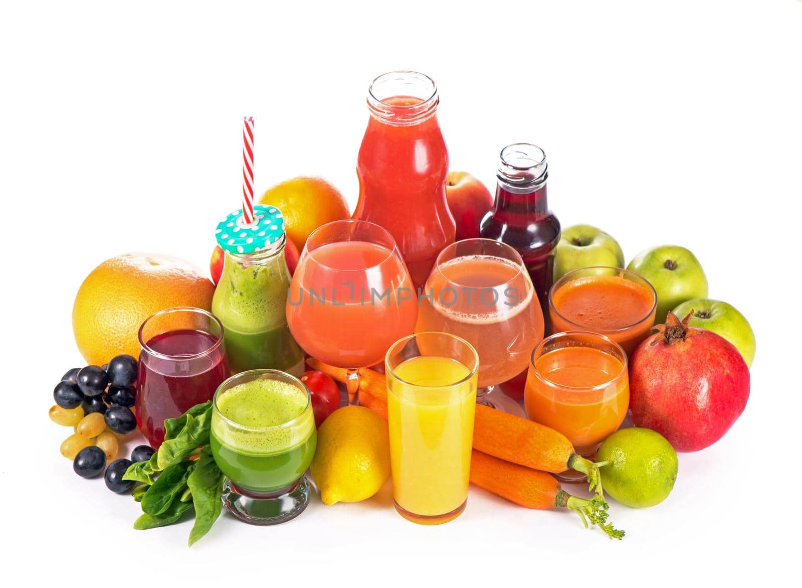 Glasses with various fresh vegetable juices on white background