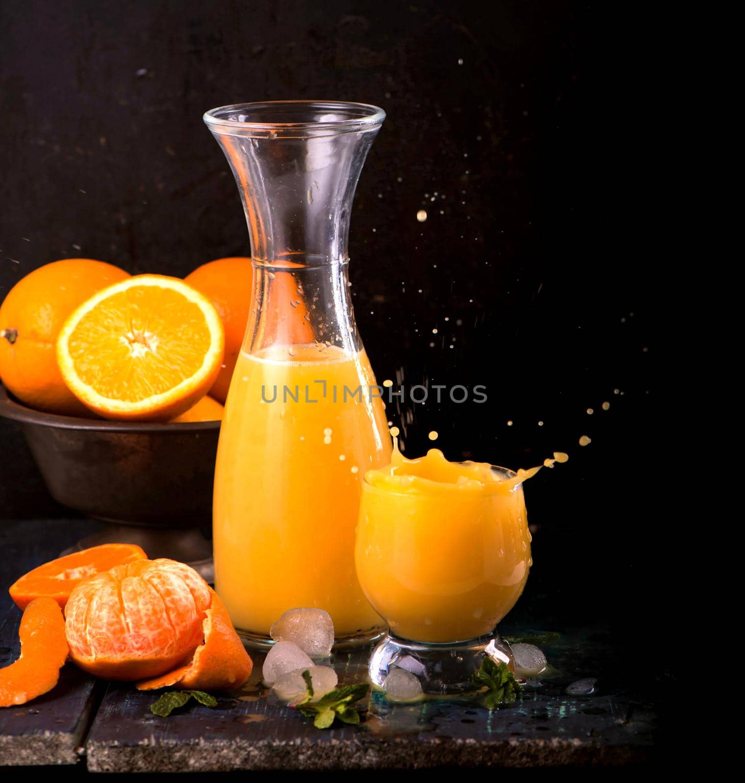 glass of fresh orange juice with fresh fruits on wooden by aprilphoto