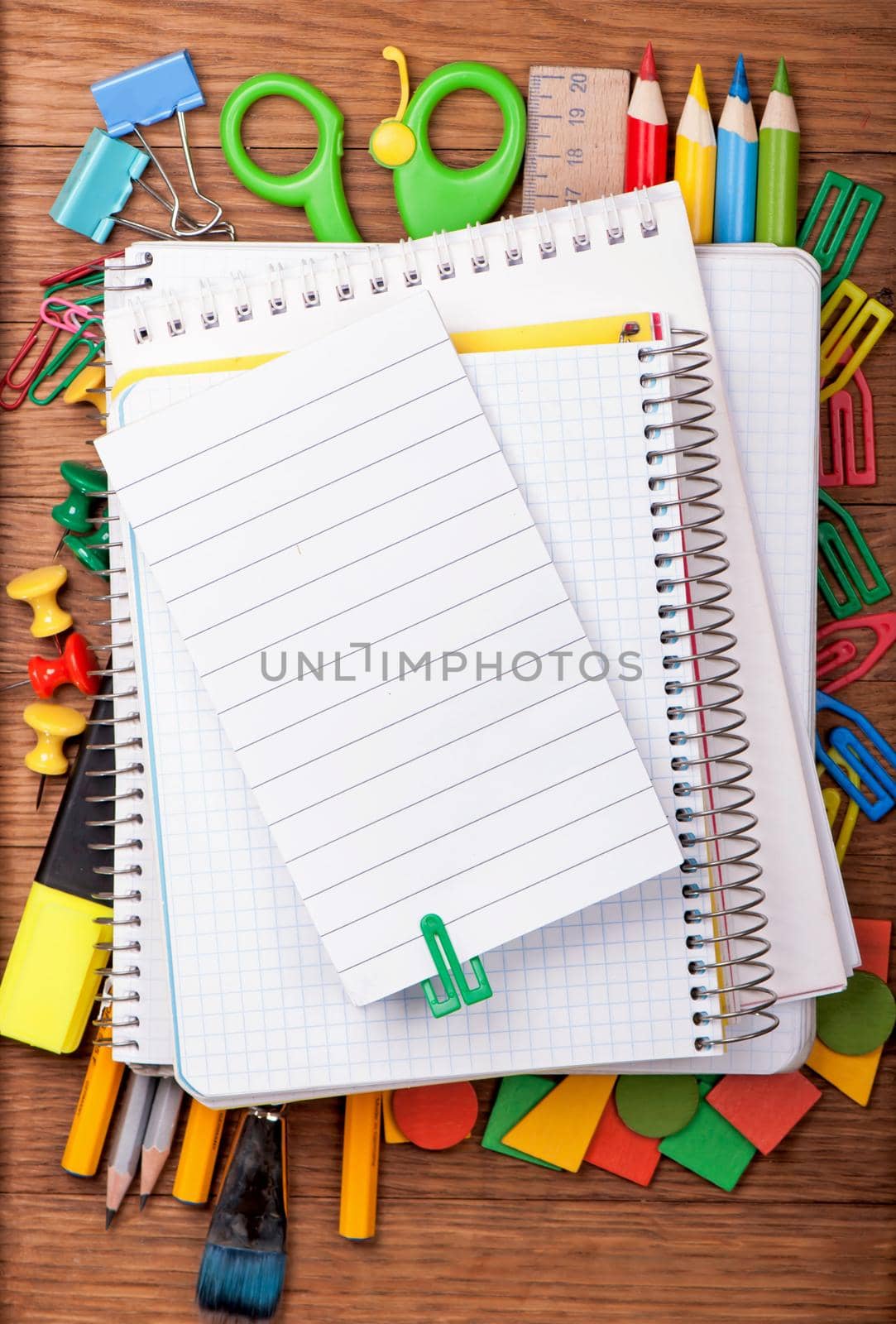 office supply and blank notepad on wooden table by aprilphoto