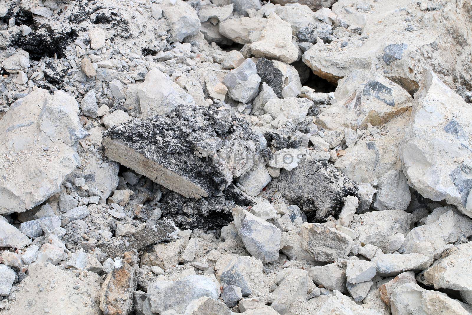 broken concrete floor at building construction site. cracked concrete texture background. Grey surface with cracks close up. A lot of pieces of splintered plaster. Abstract concept of split, dissent, by NarinNonthamand