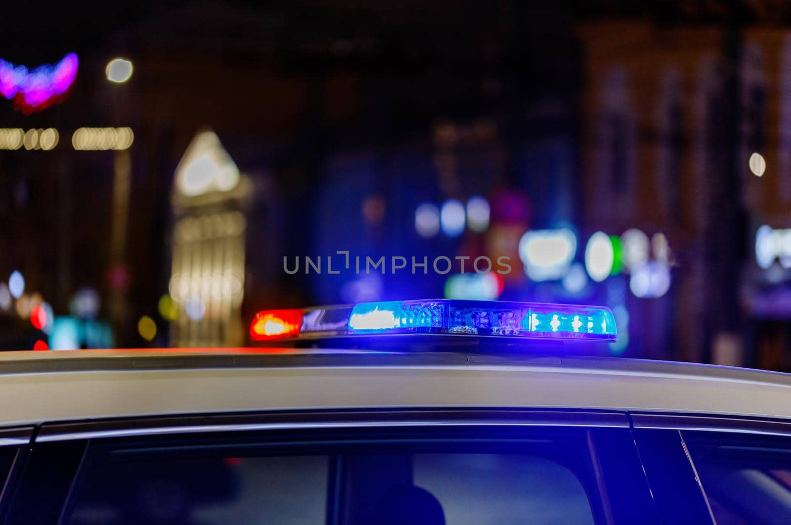 police car lights at night in city with selective focus and bokeh blur