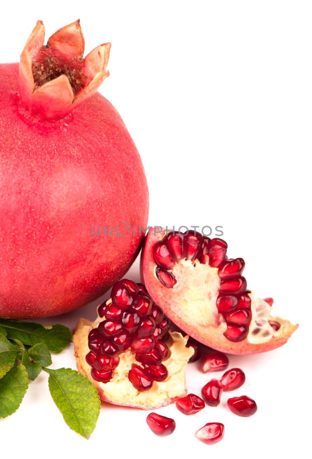 Fresh juicy pomegranate on a white background by aprilphoto