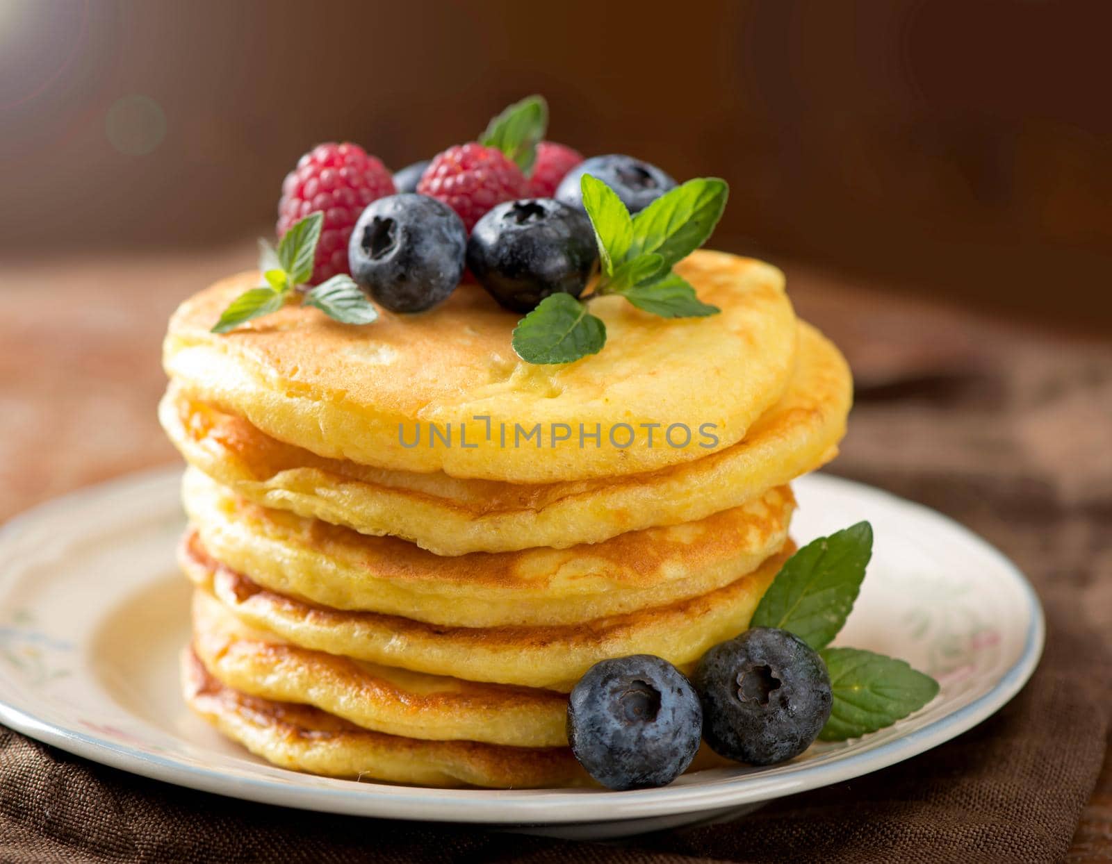 Stack of pancakes with fresh berries, close-up. by aprilphoto