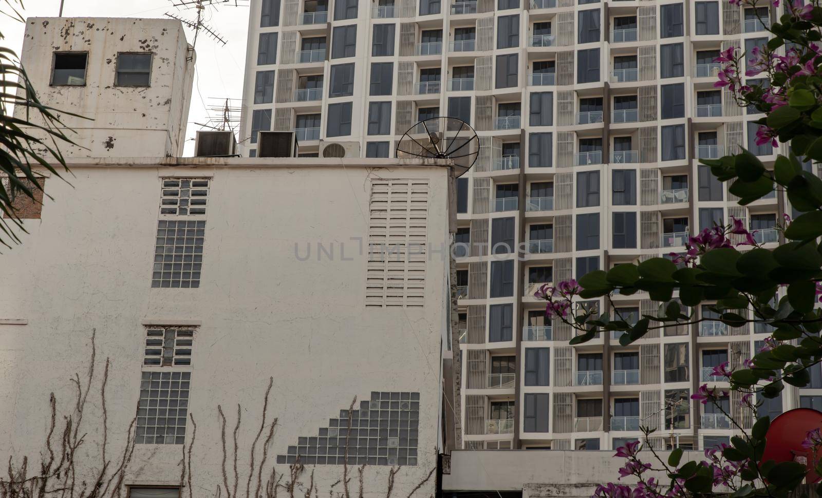 Architectural View of Overlapping old house buildings and modern condominium in bangkok, Thailand. Selective focus.