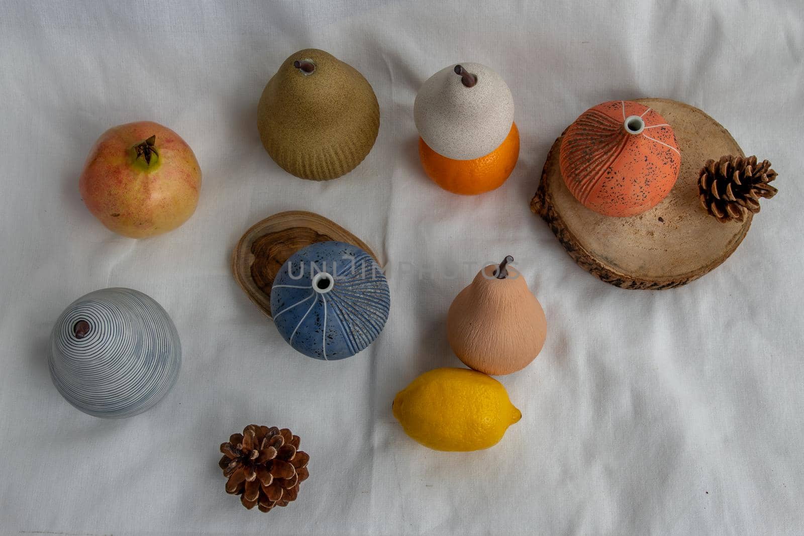 Beautiful small ceramic vases and Fresh fruits on white background. Ceramic tableware, Top view.
